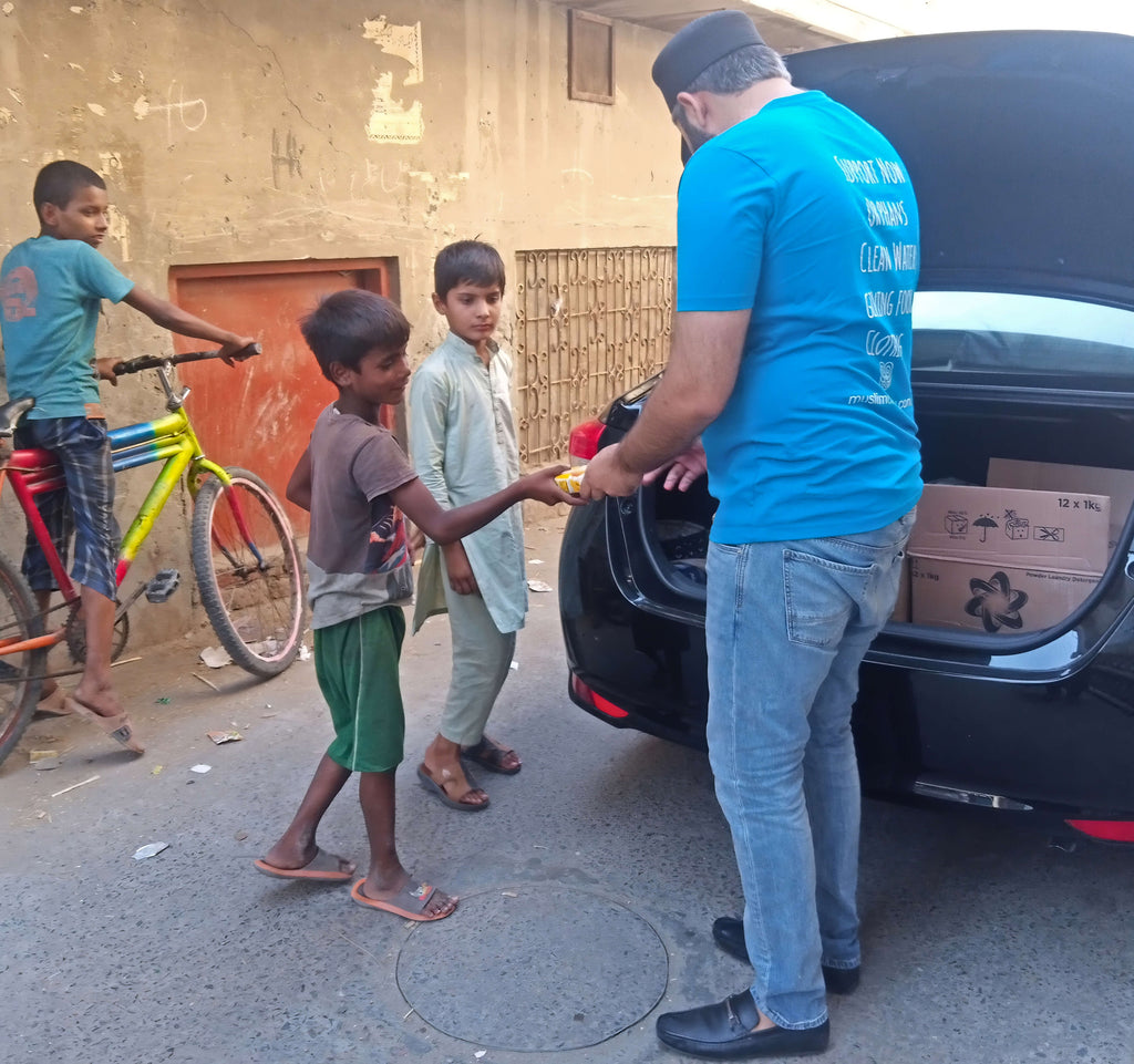 Lahore, Pakistan - Participating in Mobile Food Rescue Program by Distributing Cold Fresh Juices & Water Bottles to Less Privileged Children & People During Hot Summer Days