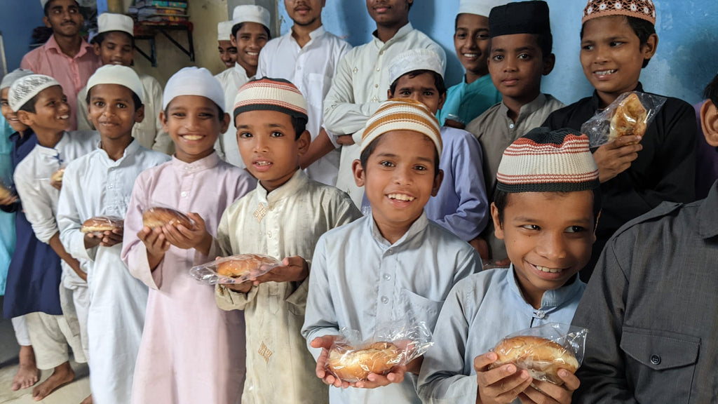 Hyderabad, India - Honoring the Welcoming of the Holy Month of Muharram & Holy Shahadat (Witnessing) of Amer l-Mumineen Sayyidina Umar al-Farouq ع by Distributing Bakery Snacks to Madrasa/School Children & Community's Homeless & Less Privileged People